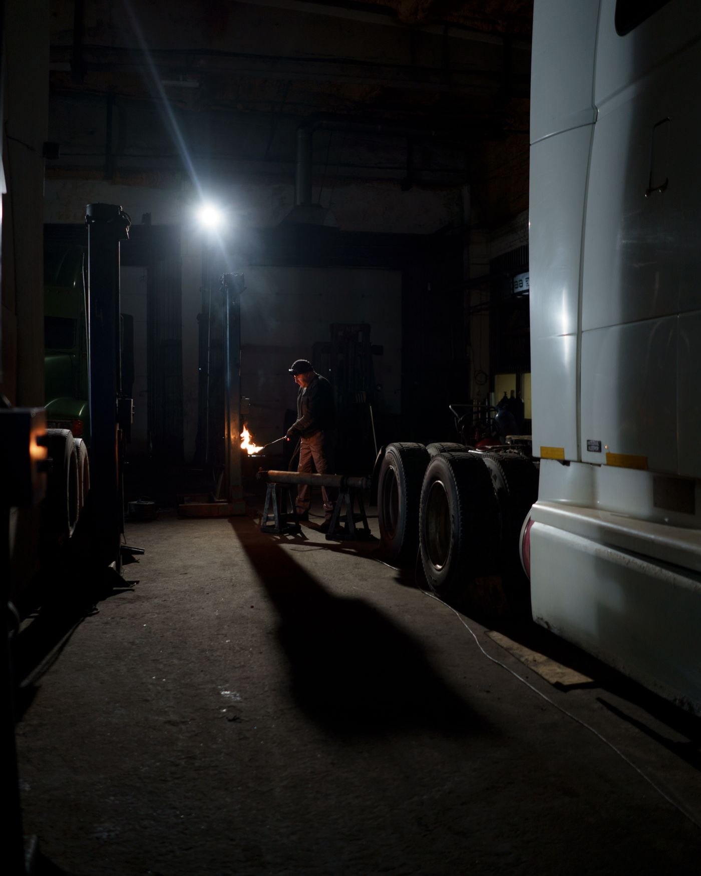 Semi truck parked inside a shop